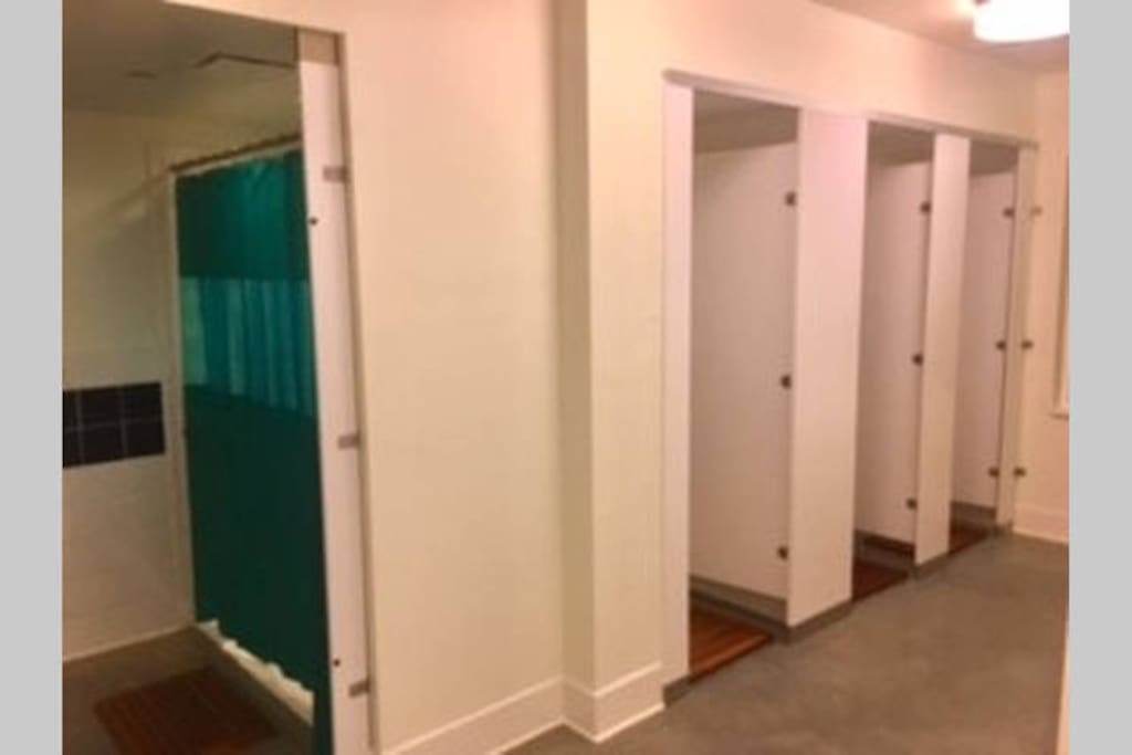 4 showers with changing area in each stall