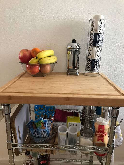 Snacks, coffee, tea, flavor packets for water, and fruit available
