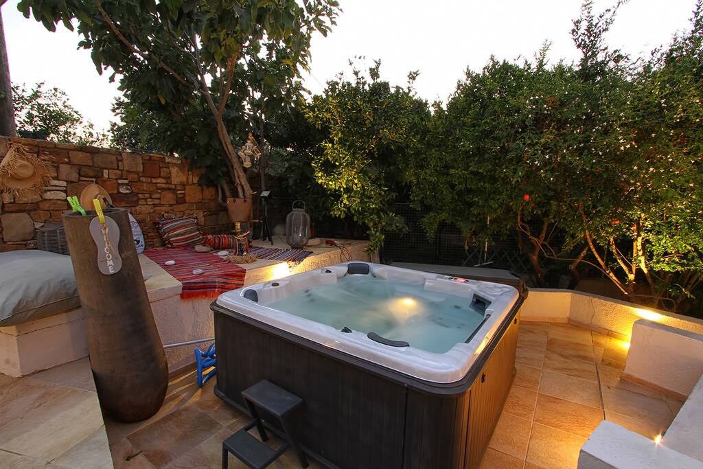 Jacuzzi next to pool and relaxing area