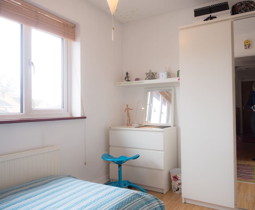A chest of drawers/desk and wardrobe