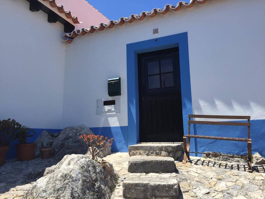 The bright blue of the sky reflected in the accents of the house