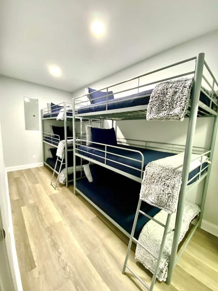 Bunk room on lower floor with two triple bunk beds!