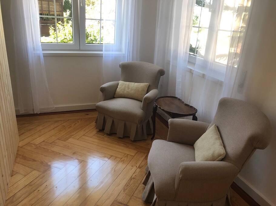 Sitting room in the room with view to the beautiful surrounding gardens. The light is magic here.