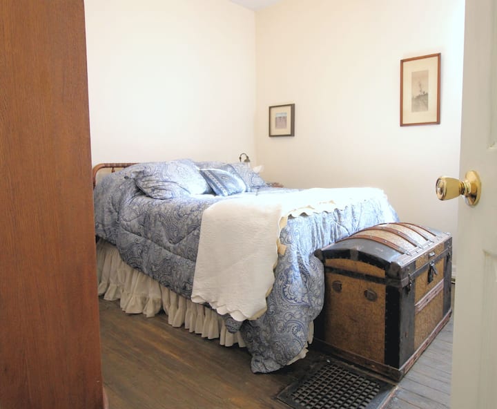 Bedroom with queen-size bed and lockable door. 
