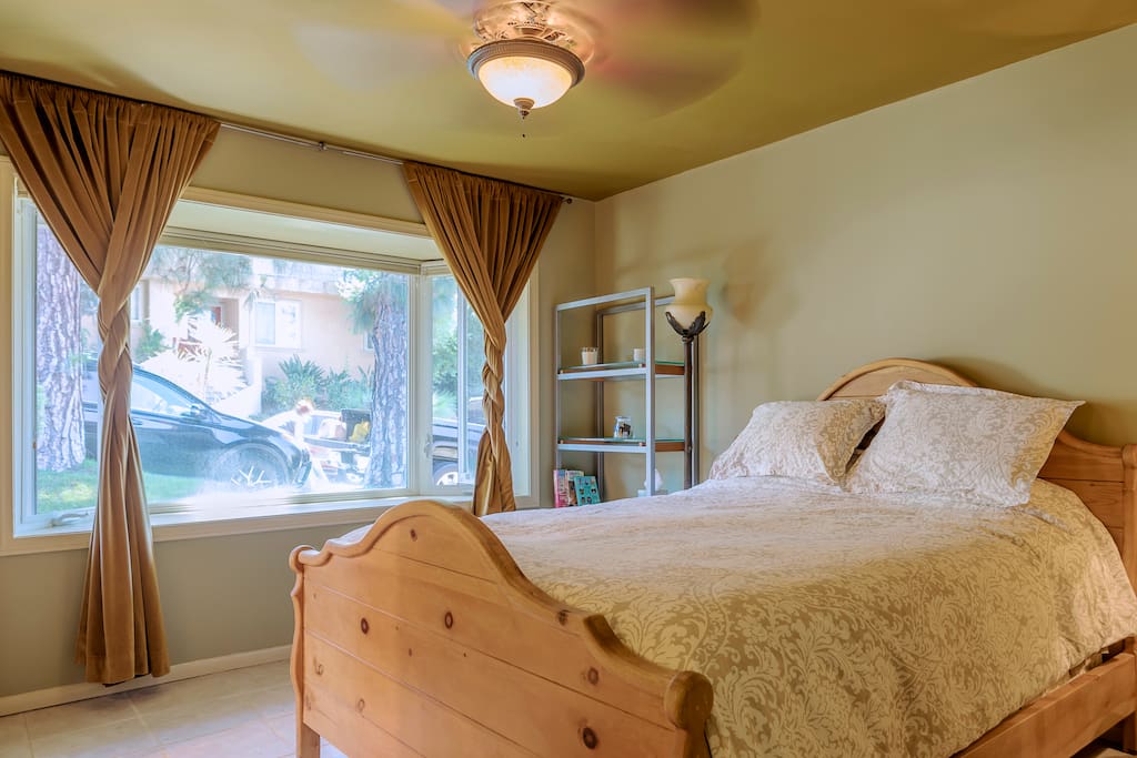 Spacious bedroom with a comfortable bed, and an armoire to store all your clothes in. The room is very sunny and bright because of the beautiful bay window, and when you want to sleep in, there are blackout curtains so you can get a good nights sleep