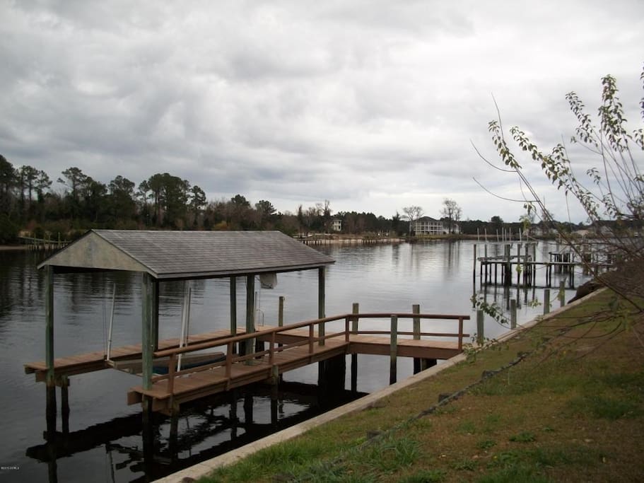 View of boat lift and dock. Good fishing spot.