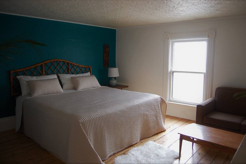 Master bedroom with love-seat and closet space