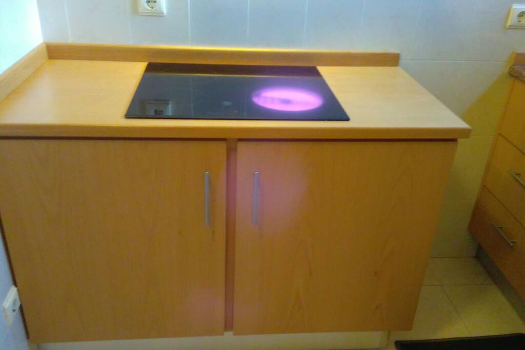 kitchen electric stove top and storage.