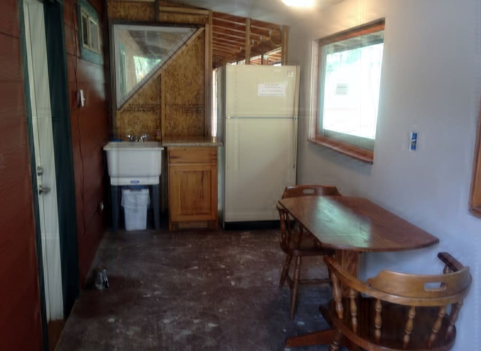 Kitchenette is under construction (please excuse the mess) but there is a working sink and fridge, dining table and small counter top. There are also 2 functioning outlets .