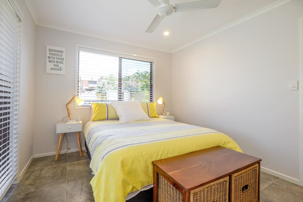 First of 2 bedrooms. Large bedroom QS beautifully comfortable ensemble, wardrobe, chest of drawers, bedside tables and reading lamps. Ceiling fan and ducted air/heating.