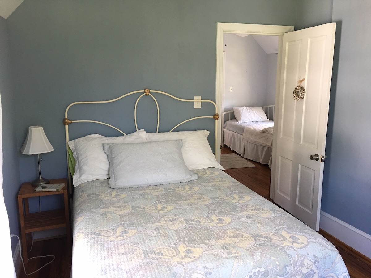 Rear bedroom with queen bed.  View to middle bedroom area with twin.