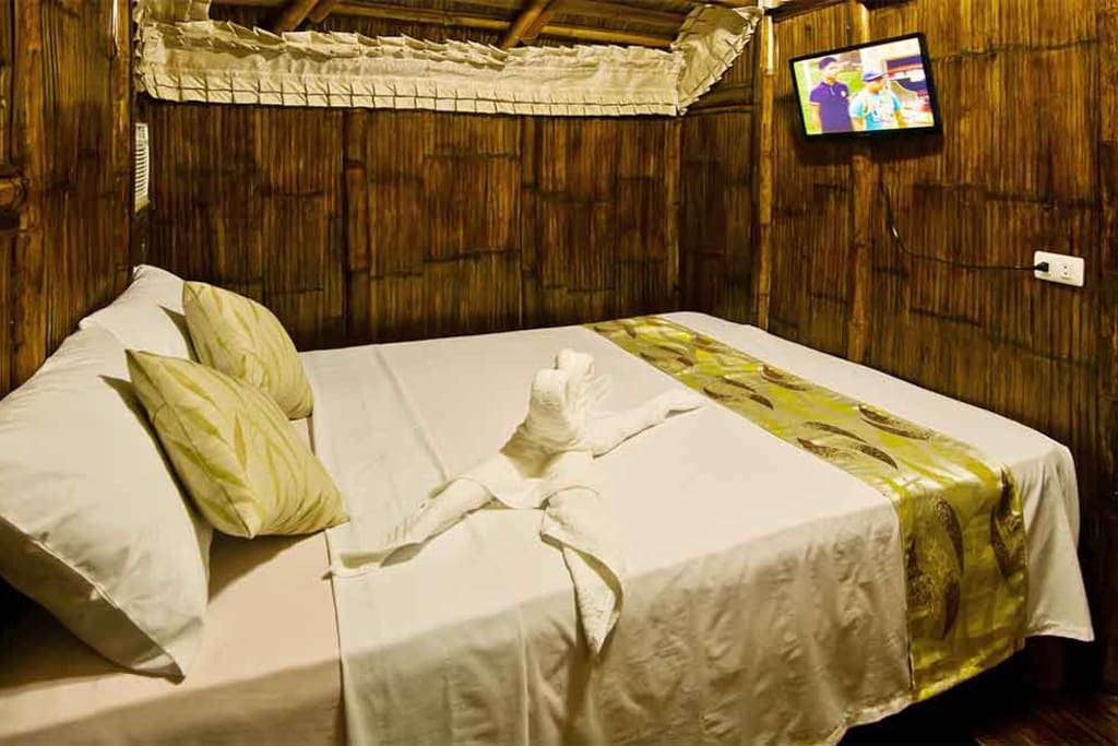 One of the 2 duplex bamboo hut bedrooms with queen size bed