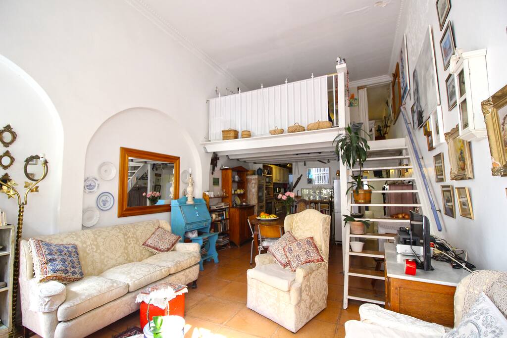 Open plan living and dining area leading to the kitchen. Stairs from the lounge up to a loft bedroom area with additional bathroom