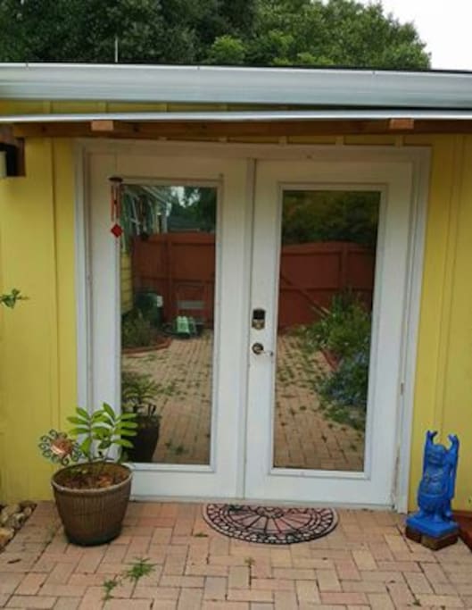 The Serenity Studio is a separate building adjacent to the hosts' home. Guests have their own private entrance via a gate that is part of a privacy fence that encloses the large backyard. This is the entry into your Serenity Studio; reflective coating on glass panels provide additional privacy.