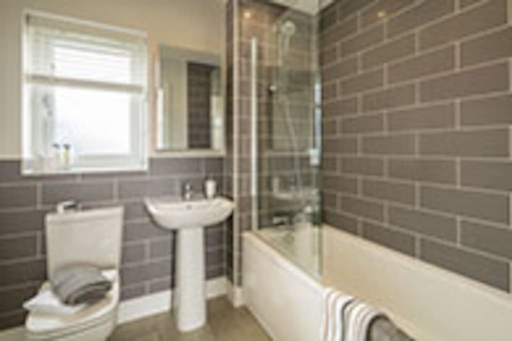 Bath and shower facilities available with complimentary toiletries.
