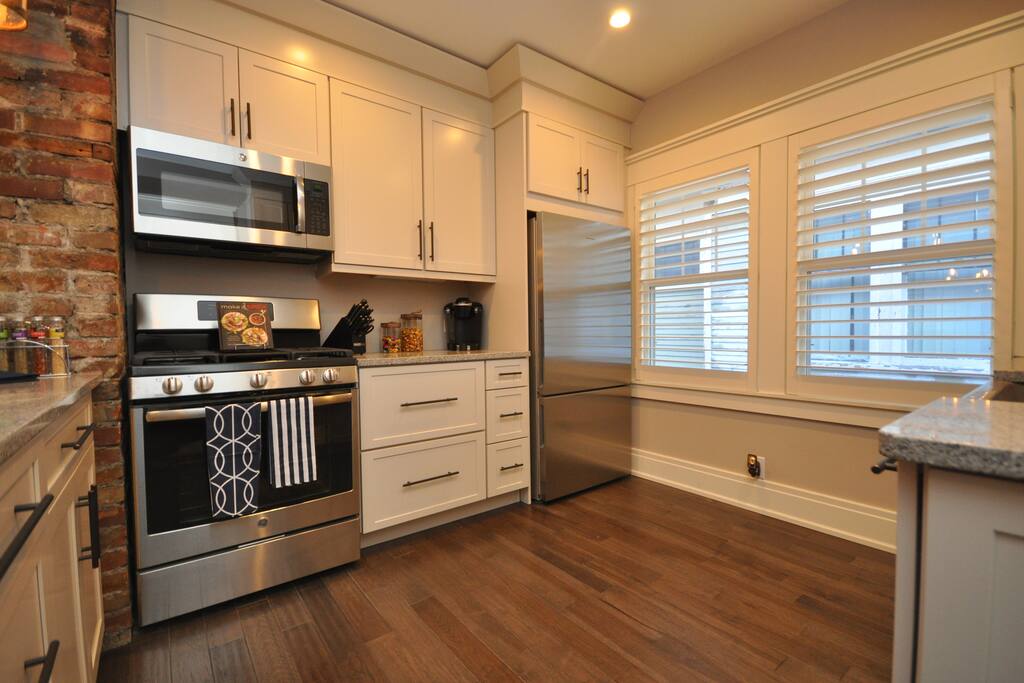 Gorgeous custom kitchen with stainless steel appliances and kitchen island.