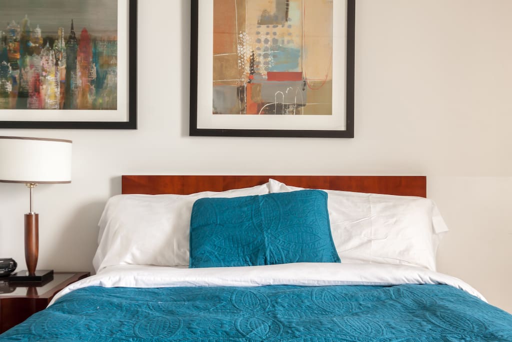 The room is furnished with 2 queen beds, a HD cable TV, a coffee table and 2 single chairs.