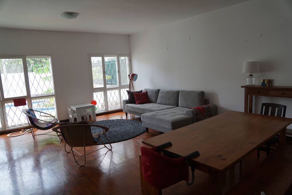 Open plan living and dining room with view of the pool