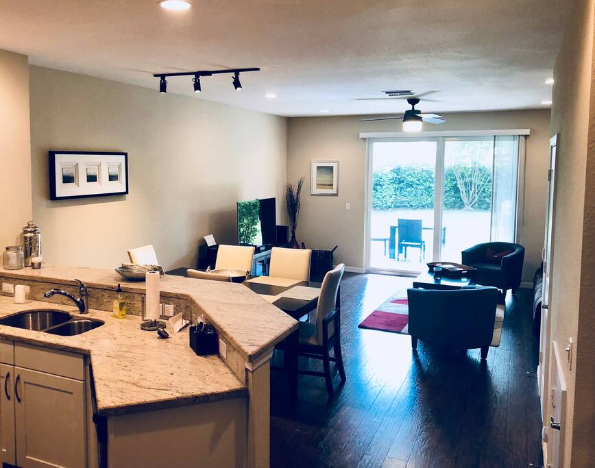 View from the entry into a beautiful kitchen, gorgeous flooring and backyard access.