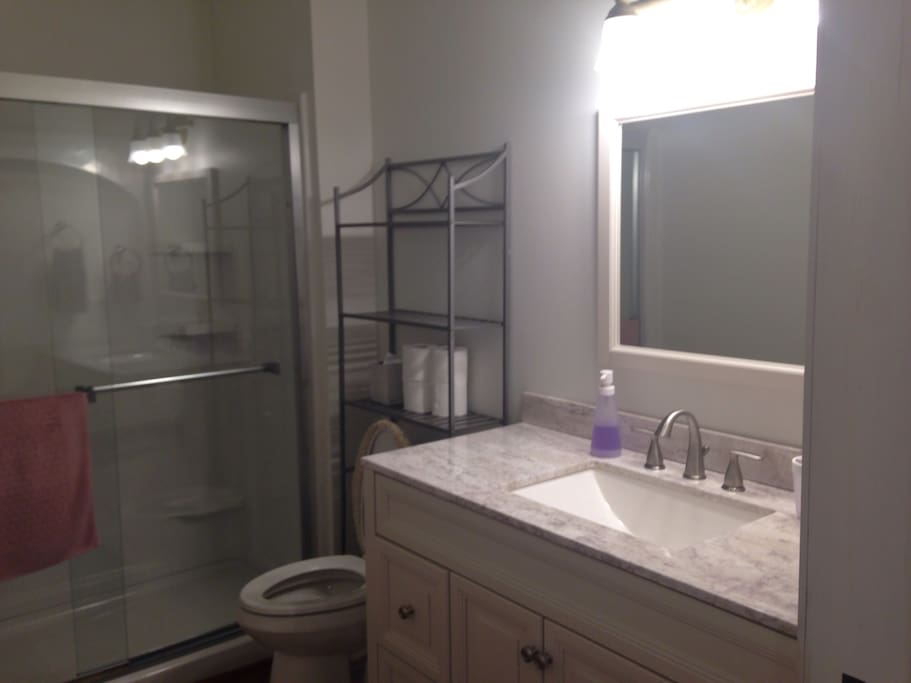 Nice, new bathroom with shower, no tub, towels and plenty of space for your things.