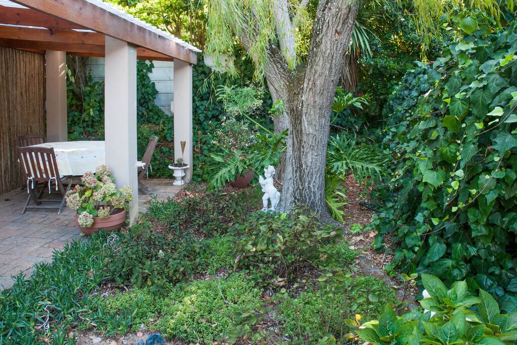 Patio table with seating area and garden. Lovely for breakfast and morning coffee