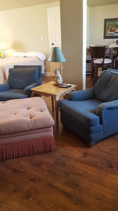 Comfortable tv watching area with ottoman. Enjoy cable tv.