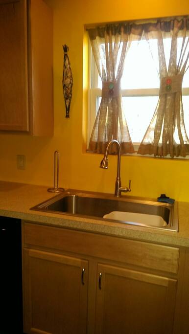 The kitchen window brightens the fully equipped kitchen for in home meals.