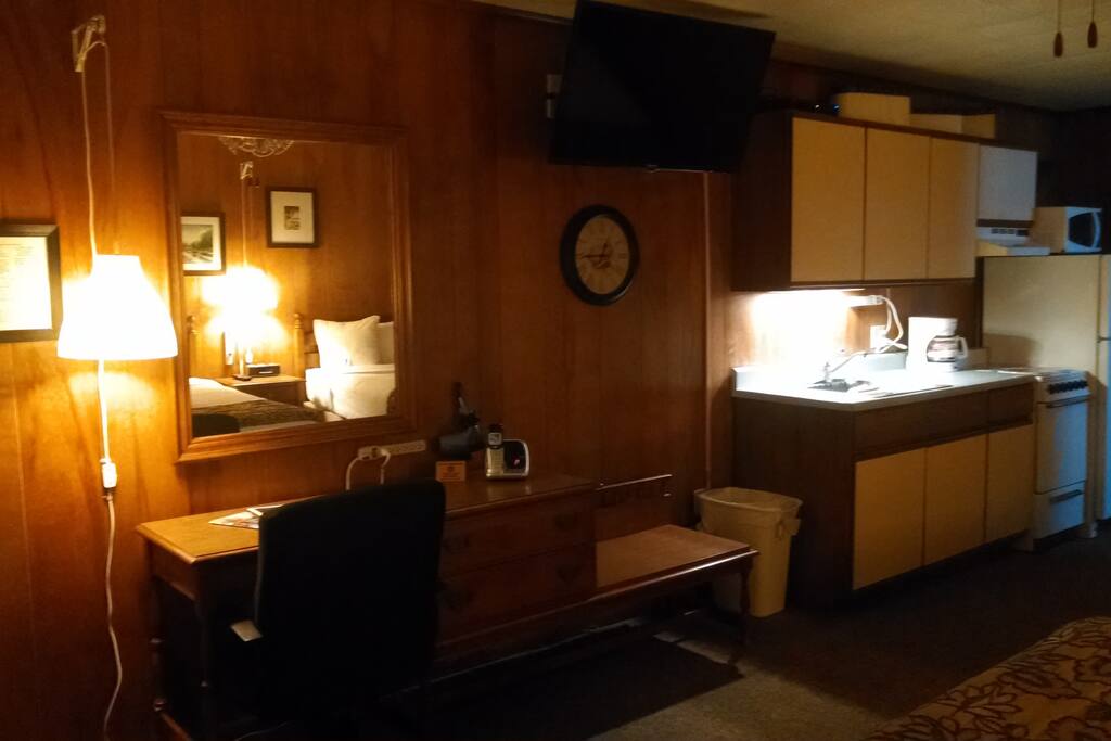 Fully stocked kitchenette w/ microwave, toaster, coffee pot, fridge w/ freezer and 4 burner stove with oven.