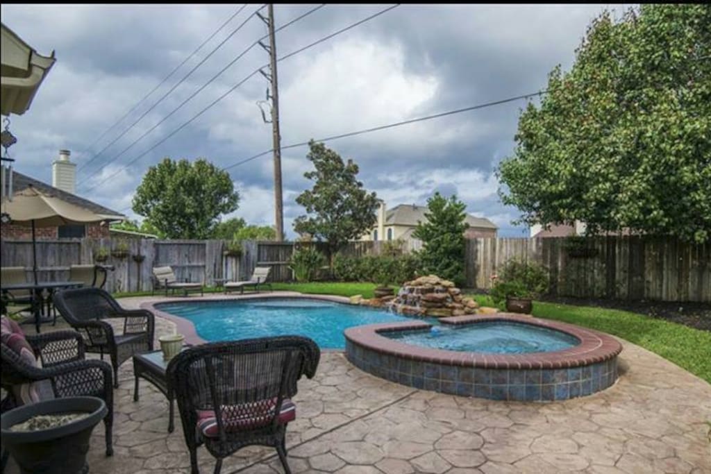 Backyard has pool and hot tub