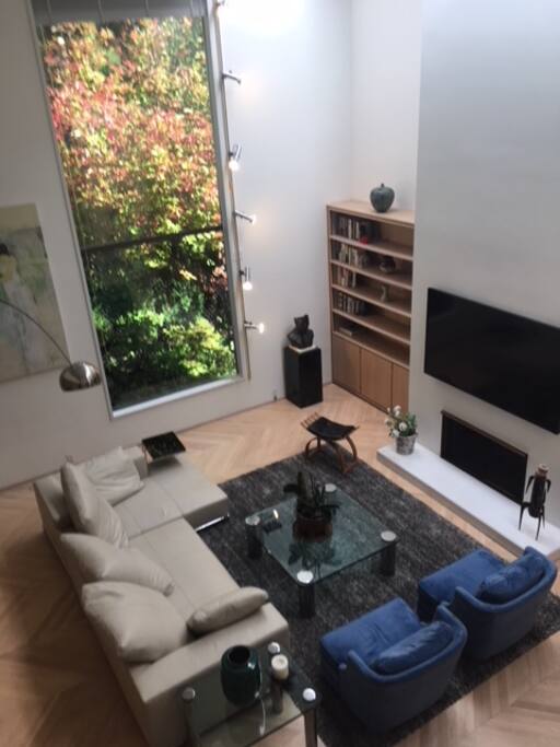 Main living area is open with wood burning fireplace and giant TV with Netflix.