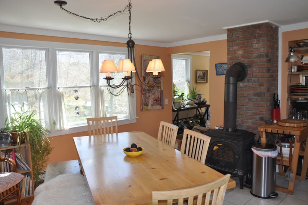 Dining table next to cozy wood stove.