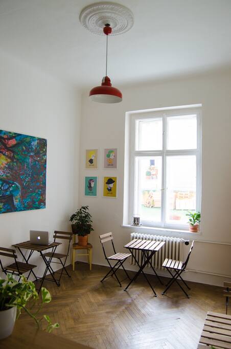 Bright and clean self-serve cafe connected to the kitchen. Art from Trevor McDonald and NinaSilla.