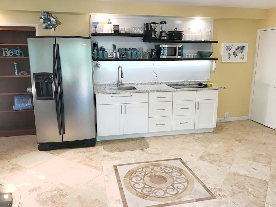 Beauty and function in your fully stocked kitchen with stunning custom travertine floor