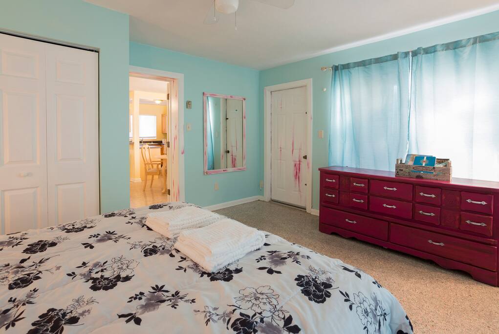 The tall, comfy, queen size bed in our Magenta room is adorned by artisanal furniture by Erica Zylman
