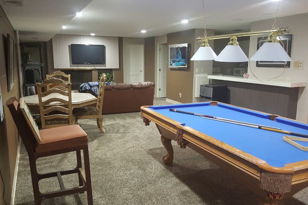Full living room with 55" TV, leather couch right off kitchen area.