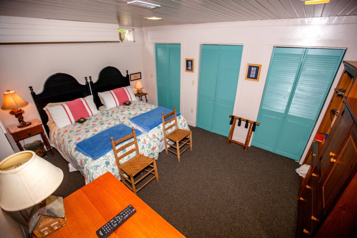 Two twin beds can easily be made into a king, depending on your needs & preferences. Closets, dressers and a TV keep you organized and entertained. The full bath on this level and stone steps leading outside makes this suite super convenient. 