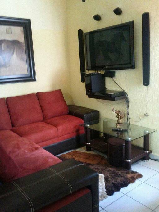 Clean living room with ample and comfortable sofas to unwind after a long day at the beach.