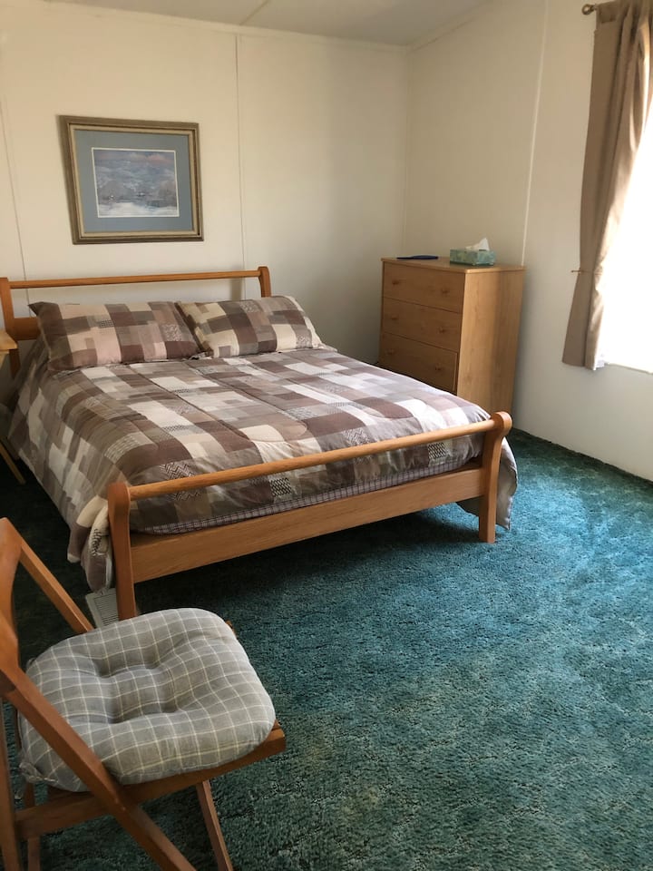 Chumba cha kulala cha mbele (upande wa mtaa) kilicho na kitanda cha ukubwa kamili, kabati la kujipambia na kabati la nguo