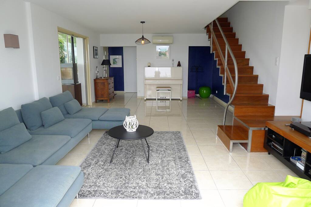 Vaste séjour de 25m2 avec accès terrasse, grand canapé d'angle, bel écran plat Sony, internet, Home Cinéma, Playstation, Wii, écran pour vidéo projecteur et véranda attenanteSalon de 35m2