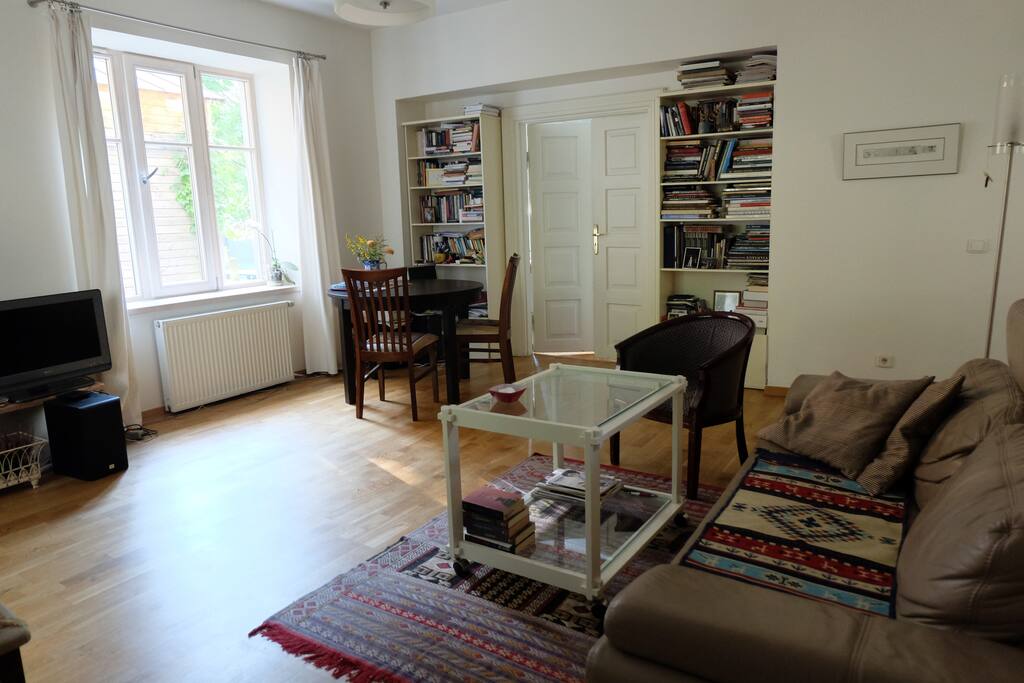 Spacious and bright open-plan living room with windows facing the courtyard. Sofa bed has an extendable king size mattres