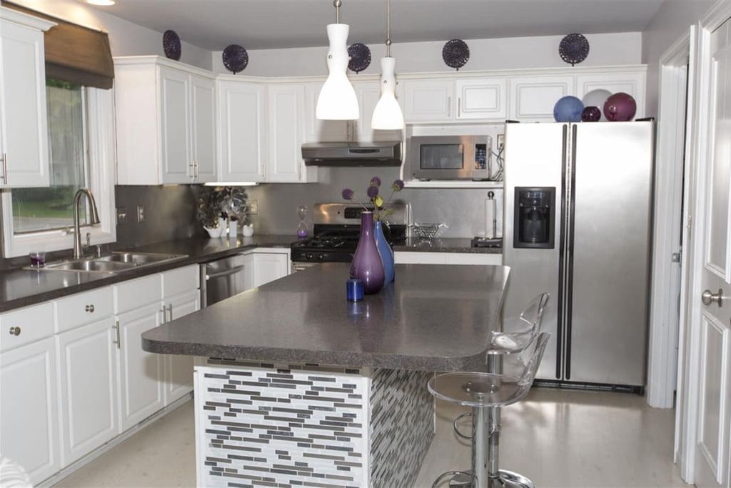 Completely stocked, modern kitchen with breakfast bar. All essentials for cooking and eating in