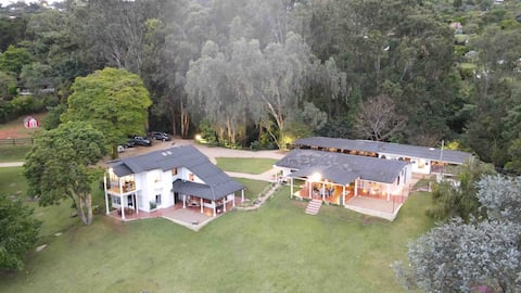 House with forest, horses and panoramic view.