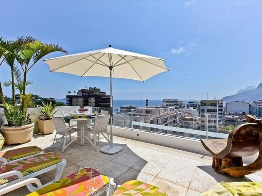 External lounge area with table, chairs and umbrella