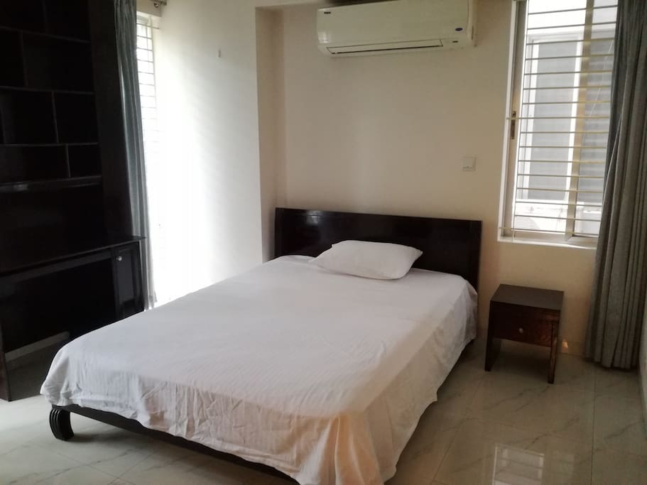 This the third room of our apartment. There is also one attached bathroom, one king size bed with one side drawer, one reading table. Air Condition is also available.
