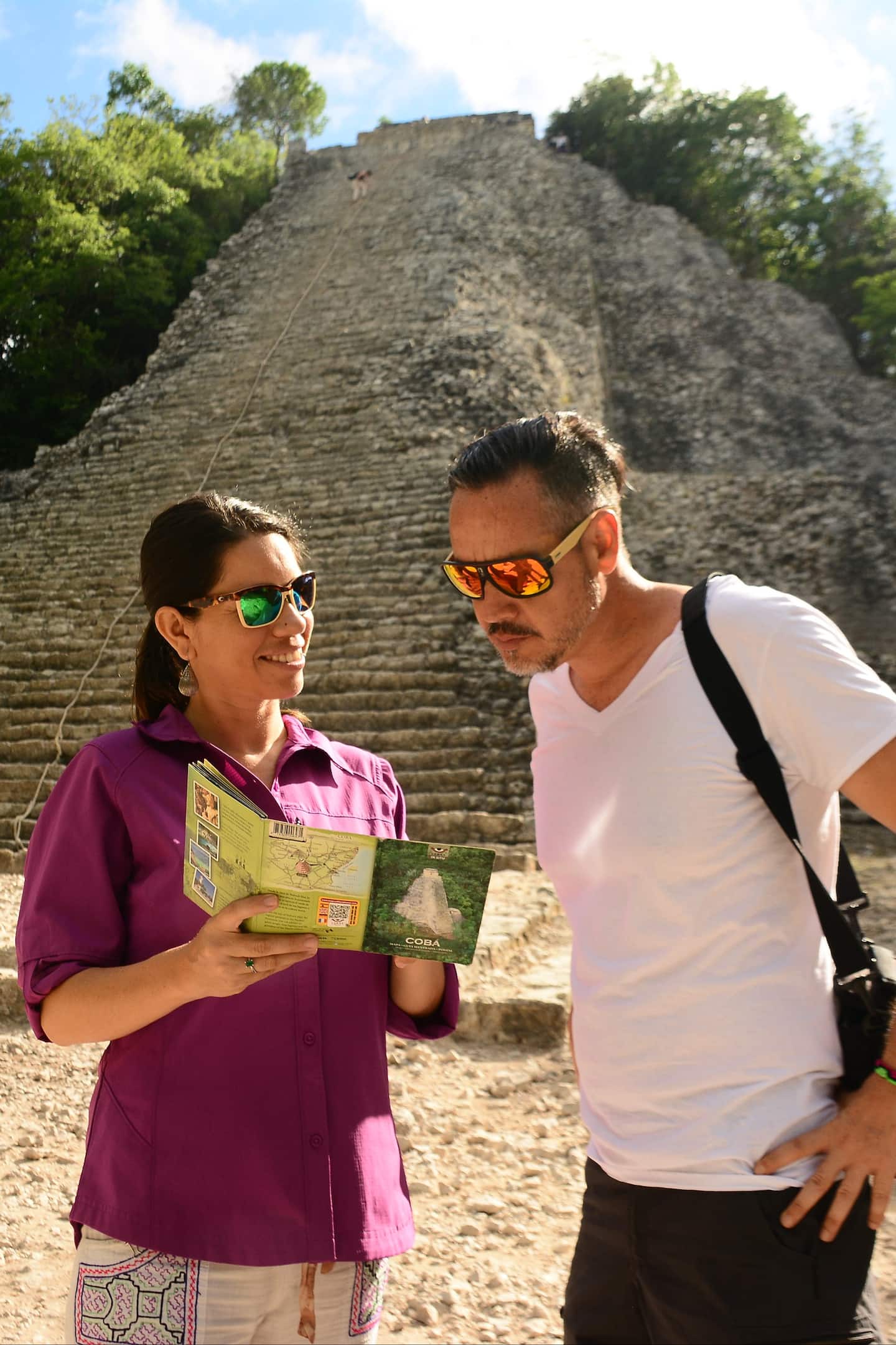 two tourists looking up to Coba Pyramid