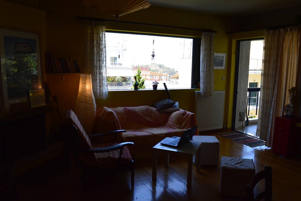 Living room's window and front balconi door (the sofa can be used as a double bed)