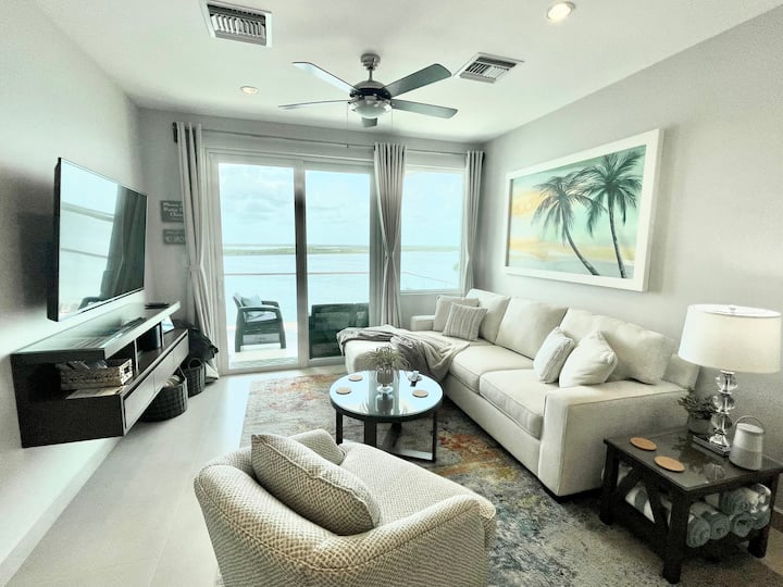 Living area: 57” smart TV, queen-sleeper sofa and basket with pool/beach toys.