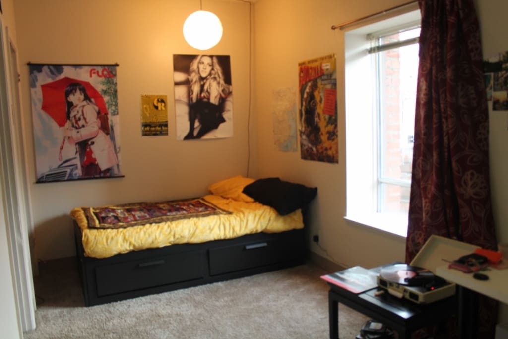 Left/West Side: Bed area and Record Player.