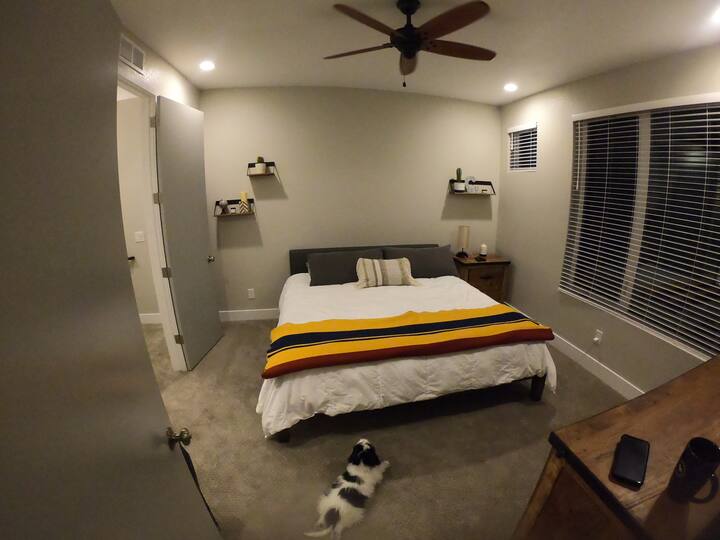 The master bedroom features a king size bed with plenty of space (puppy not included ).