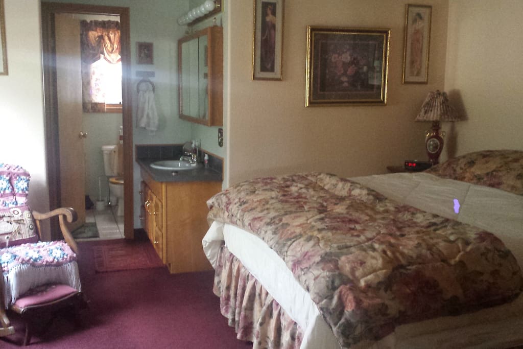 King size bed with bathroom, shower attached.